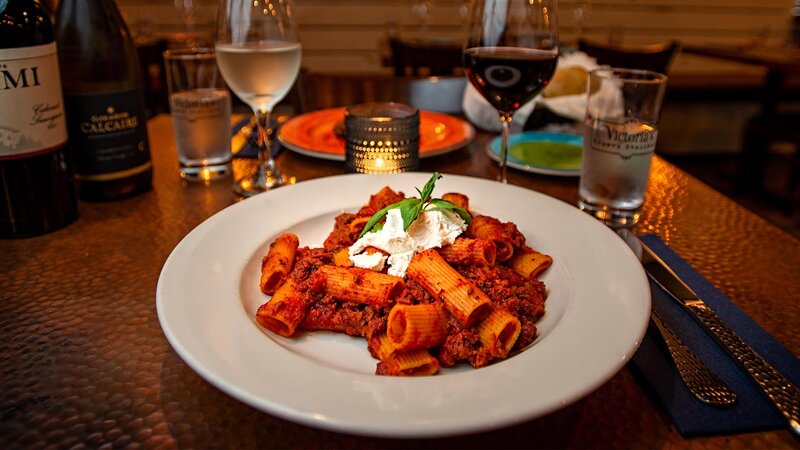 Rigatoni with tomato meat sauce topped with ricotta