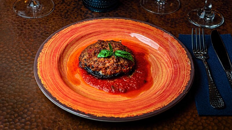 Portobello mushroom topped with pomodoro sauce and sausage