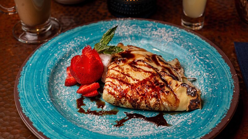 Crepe dessert with chocolate sauce and strawberry