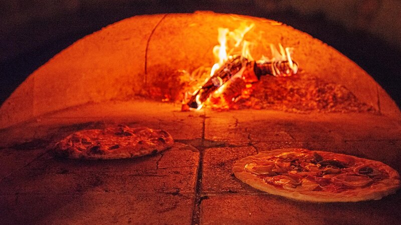 Brick oven pizza with two pizzas inside